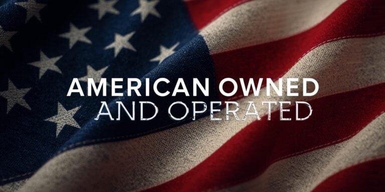 Close‑up of a flowing U.S. flag with the words “American Owned and Operated” overlayed in bold white letters.